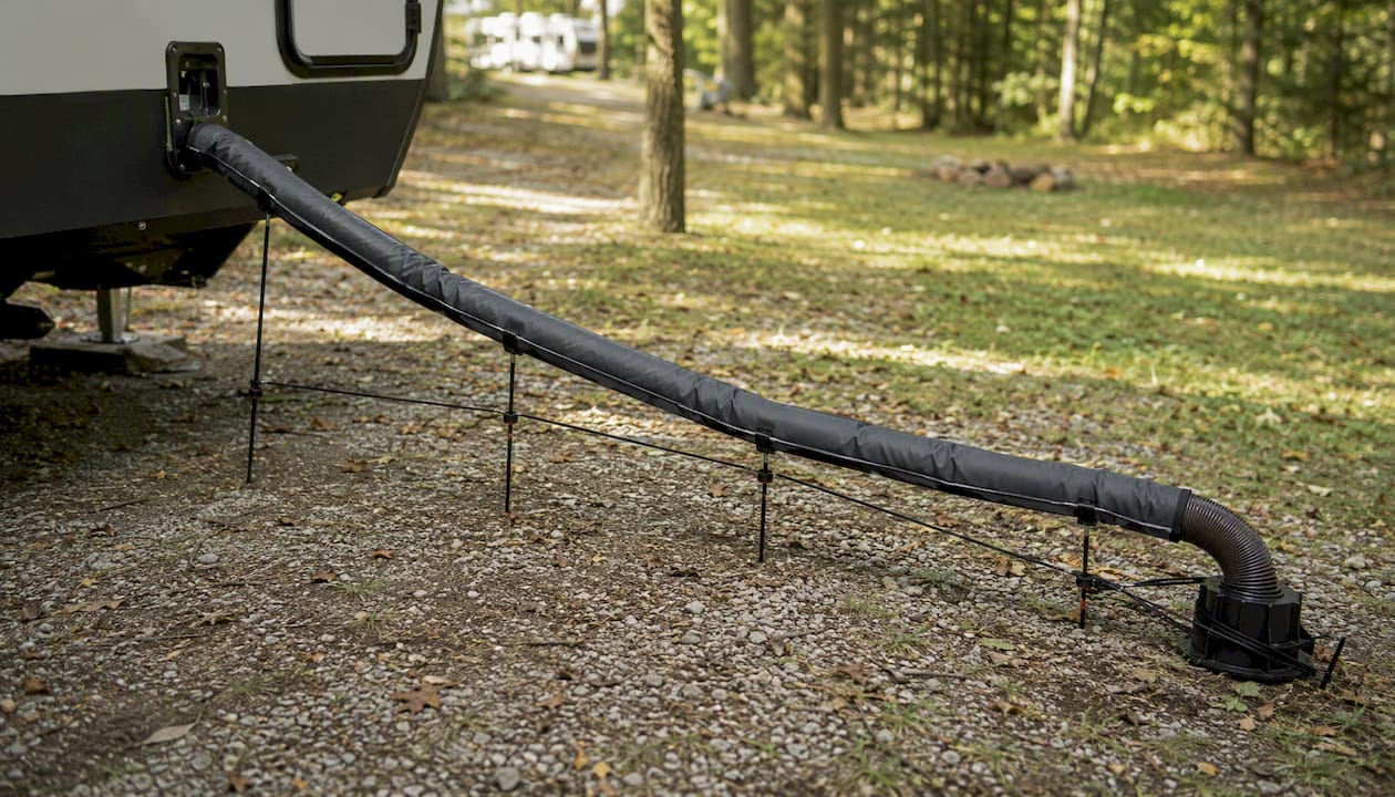 RV sewer hose supported above uneven ground