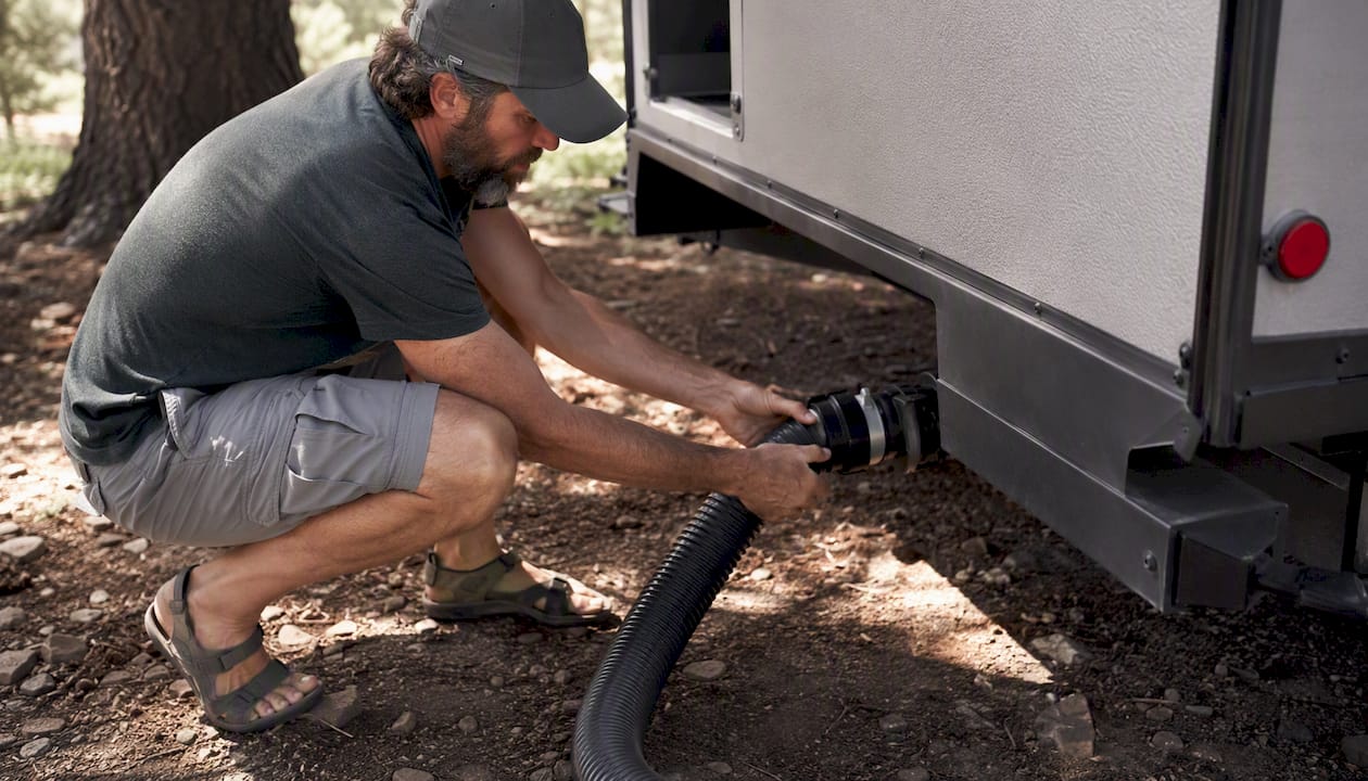 RV sewer hose tight connection at gravel campsite